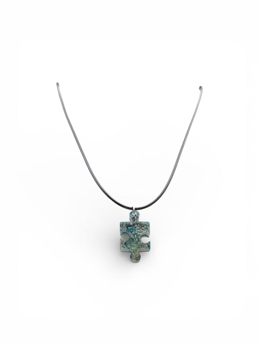 Necklace with a blue and silver pendant on a white background