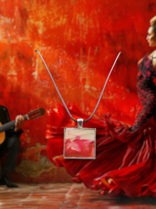 Necklace with a square pendant in front of a person in a red dress against a red wall.