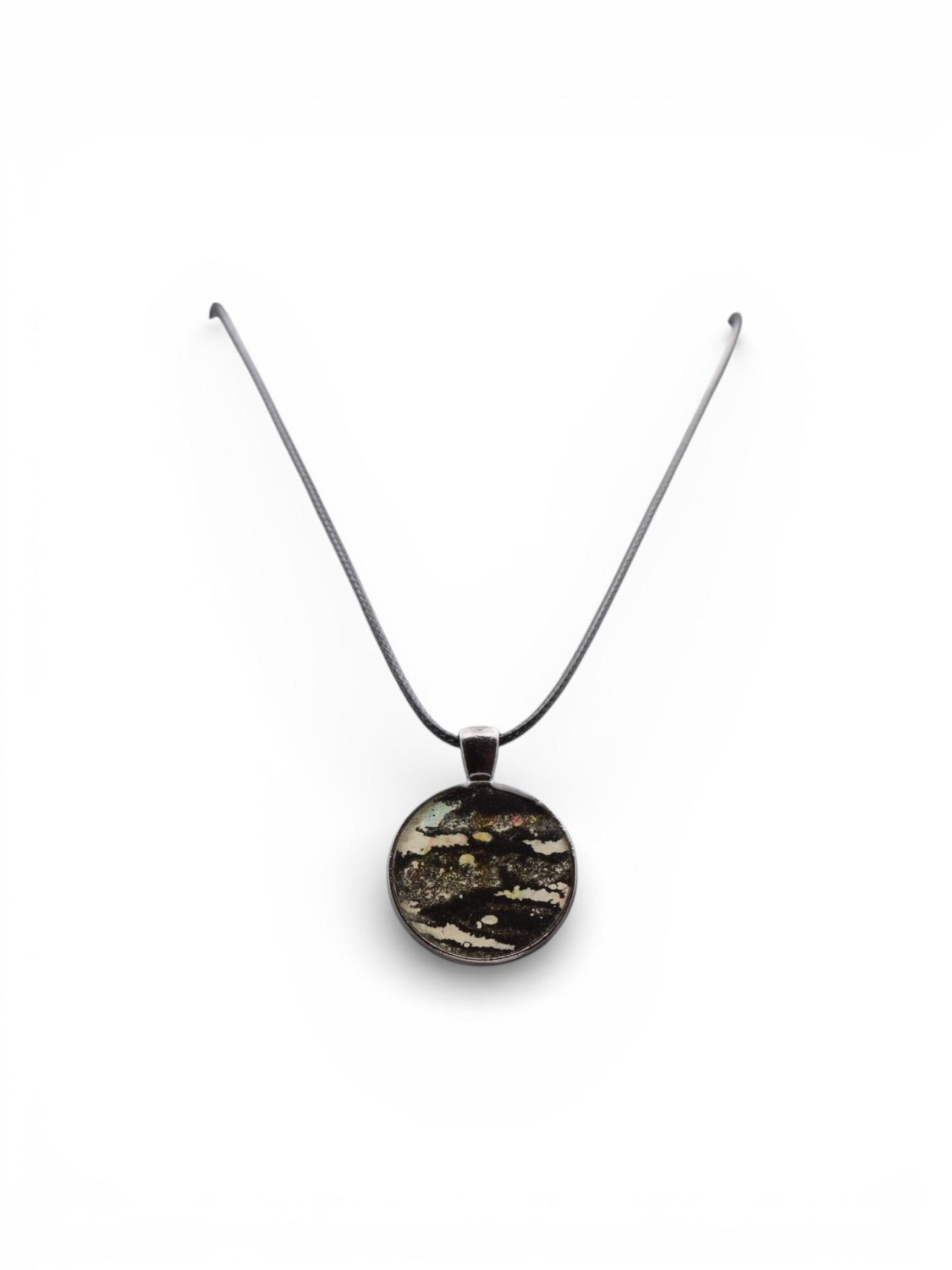 Dark round pendant necklace on a white background