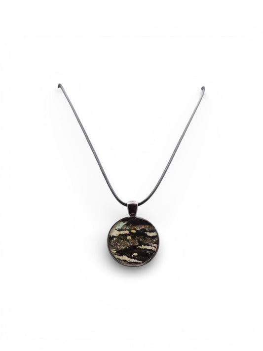 Dark round pendant necklace on a white background