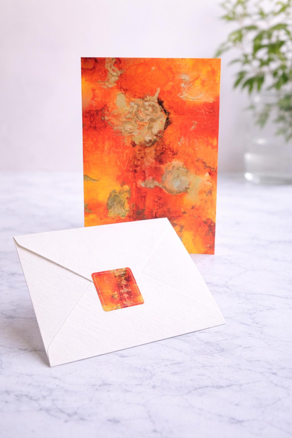 Greeting card with abstract design and envelope on a marble surface